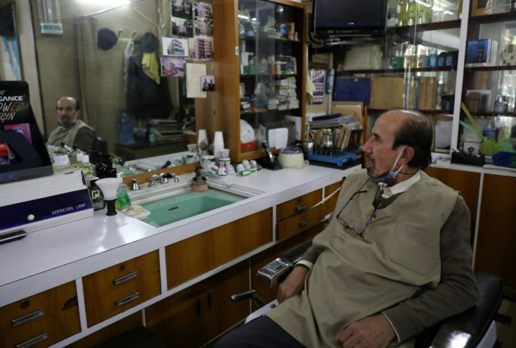 Civil war survivor Victor Abu Kheir, 77, in his barber shop in the Lebanese capital Beirut's Hamra neighbourhood