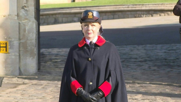 Royal staff and police officers stand at the entrance of Windsor Castle on the third day of national mourning