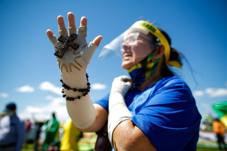 Marchers demanded "religious freedom," warned against "communist" influence and voiced support for President Jair Bolsonaro, a conservative Catholic who has strongly opposed local bans on religious services