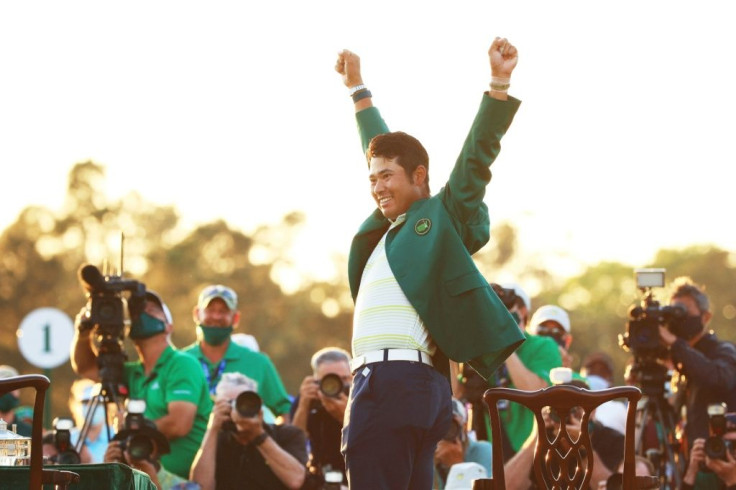 Hideki Matsuyama celebrates after becoming the first Japanese man to win a golf major with his victory at Sunday's Masters