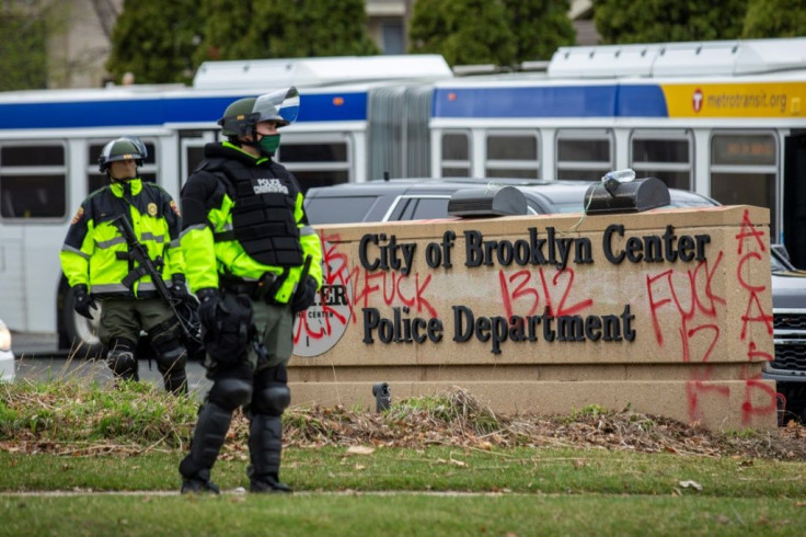 Law enforcement officers stand guard outside the police station in Brooklyn Center, the Minneapolis suburb where the shooting of Daunte Wright took place