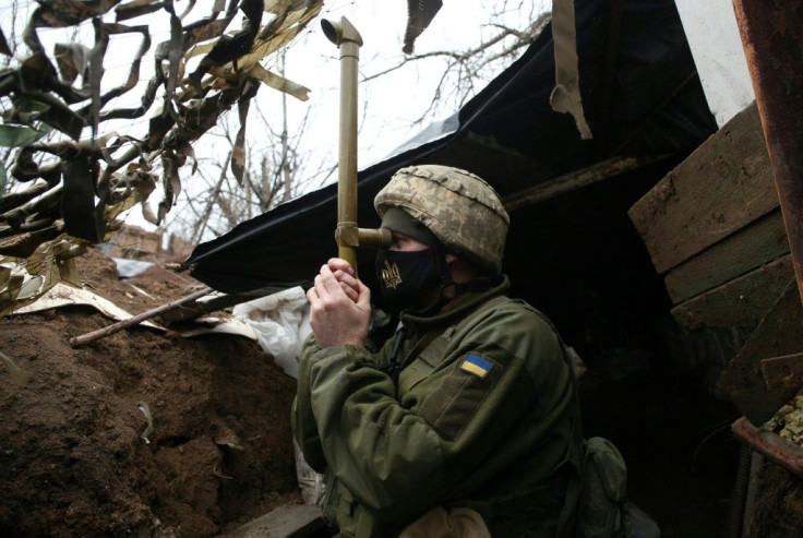 A Ukrainian soldier stands guard on the frontline with Russia-backed separatists. Clashes have picked up again since the start of the year