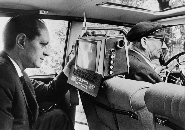 A taxi passenger watches the 1964 Tokyo Olympics in Hamburg, Germany. Japanese tech transformed the Games - AFP