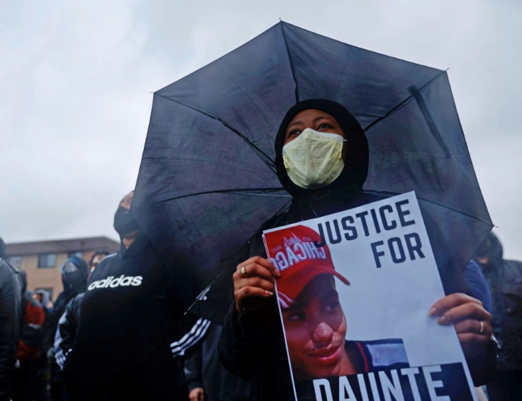 People gather at the start of the curfew to protest the death of Daunte Wright who was shot and killed by a police officer in Brooklyn Center, Minnesota