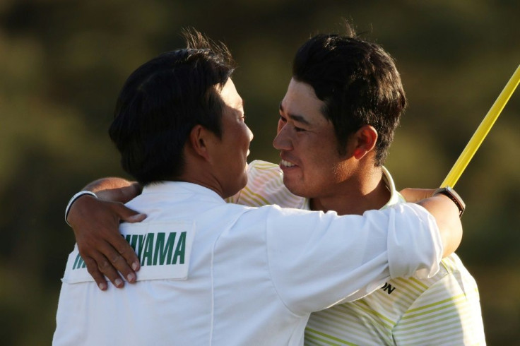 Hideki Matsuyama (right) hugs his caddie, Shota Hayafuji after winning the Masters