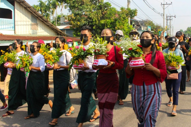 Protestors march with flower pots in Dawei. A junta crackdown against dissent has left more than 700 dead