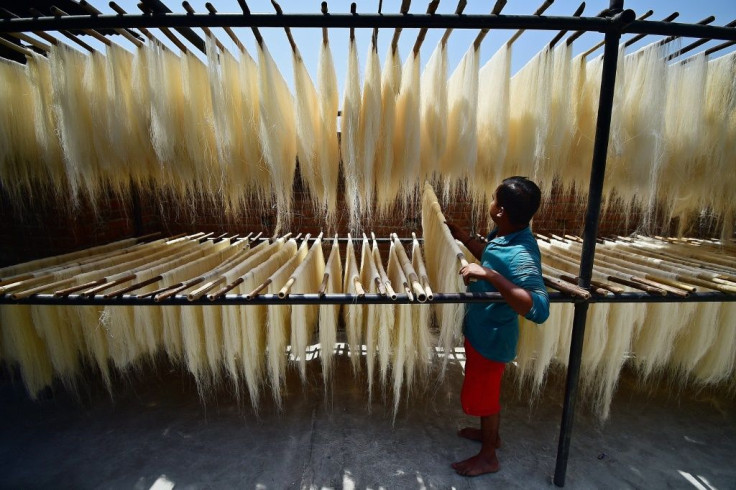 Workers prepare vermicelli which is used in a traditional sweet dish popularly consumed during the holy month of Ramadan at a factory in Allahabad, India