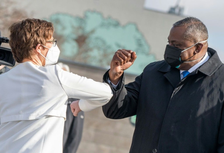 US Defense Secretary Lloyd Austin bumps elbows with his German counterpart Annegret Kramp-Karrenbauer