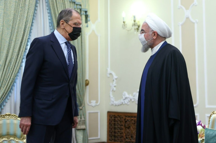 Russian Foreign Minister Sergei Lavrov is received by Iranian President Hassan Rouhani as he puts on a united front with his hosts on bringing the United States back into a troubled 2015 nuclear deal