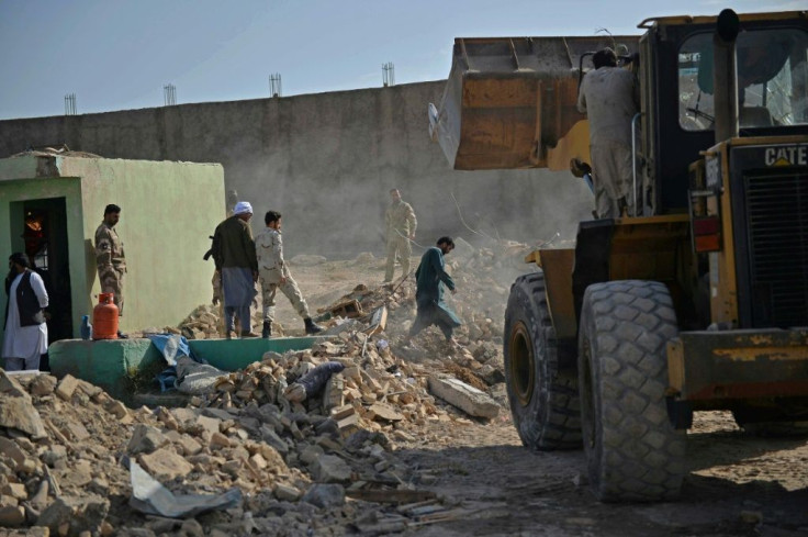 Security personnel and rescuers arrive at the site of a bomb blast in Afghanistan's Herat province on April 1, 2021.