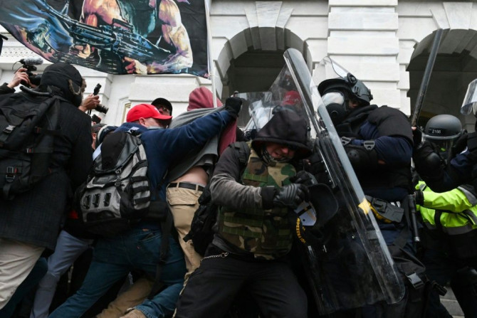 Riot police push back supporters of then-president Donald Trump on January 6, 2021 after they attacked the Capitol building in Washington