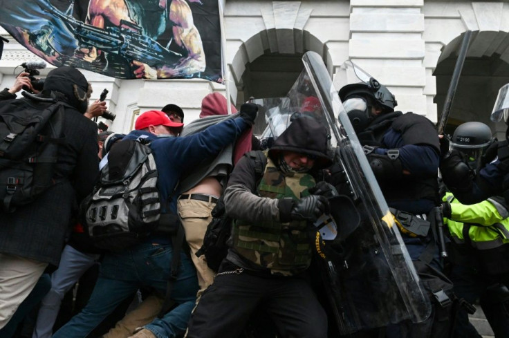 Riot police push back supporters of then-president Donald Trump on January 6, 2021 after they attacked the Capitol building in Washington