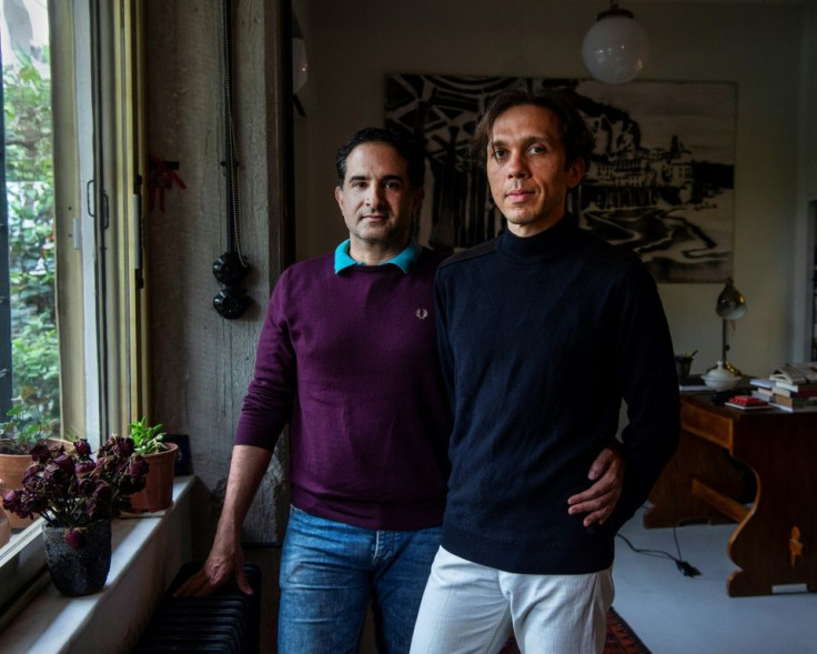 Greek national Alexandros Massavetas (left) and  Cihan Tutluoglu of Turkey are pictured in their Athens home