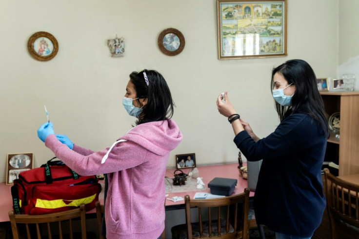 Medics in the Cypriot mountain village of Kyperounta prepare to inoculate a resident with the AstraZeneca vaccine