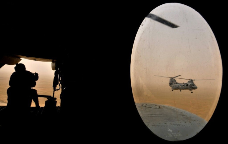 A US soldier (L) sits in the rear of a Marine Chinook helicopter while flying over Helmand province, southwest of Kabul on May 3, 2008 -- in the first decade of the war that US President Joe Biden now says he will end without conditions