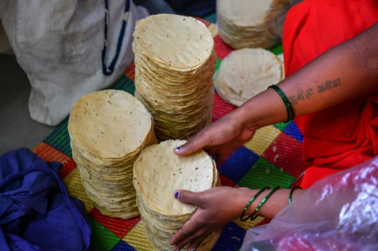 Lijjat's commitment to women's empowerment reflects its beginnings, when seven housewives gathered on a Mumbai rooftop one morning to prepare papads