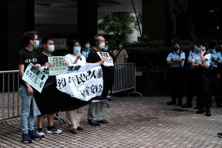 Four democracy activists held a lonely rally flanked by dozens of police officers