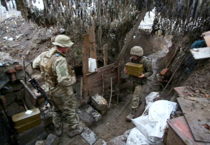 Ukrainian servicemen keep watch at a position on the frontline with Russia-backed separatists near Gorlivka, Donetsk region