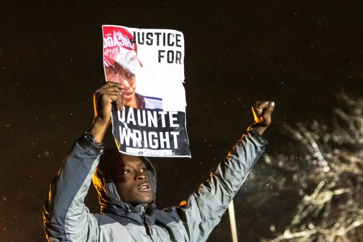 A demonstrator holds a photo of Daunte Wright during a protest in Brooklyn Center, Minnesota