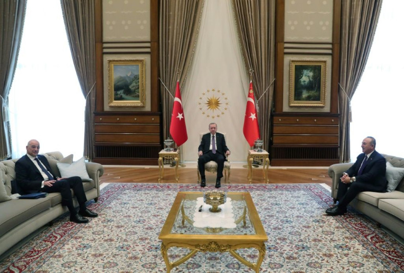 Turkish President Recep Tayyip Erdogan, seated at centre, receives Greek Foreign Minister Nikos Dendias, at left, at the presidential complex in Ankara