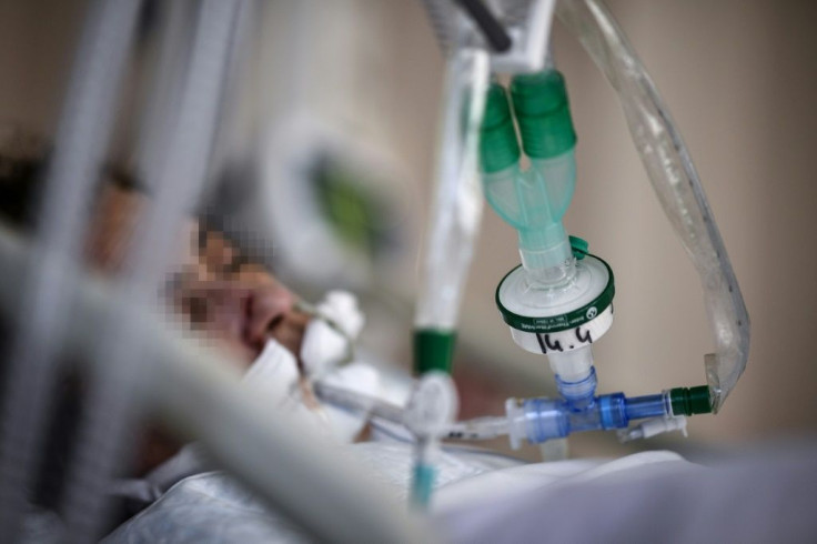 A patient infected with Covid-19 lays in a bed in the intensive care unit of the Saint-Camille hospital, in Bry-Sur-Marne, east of Paris