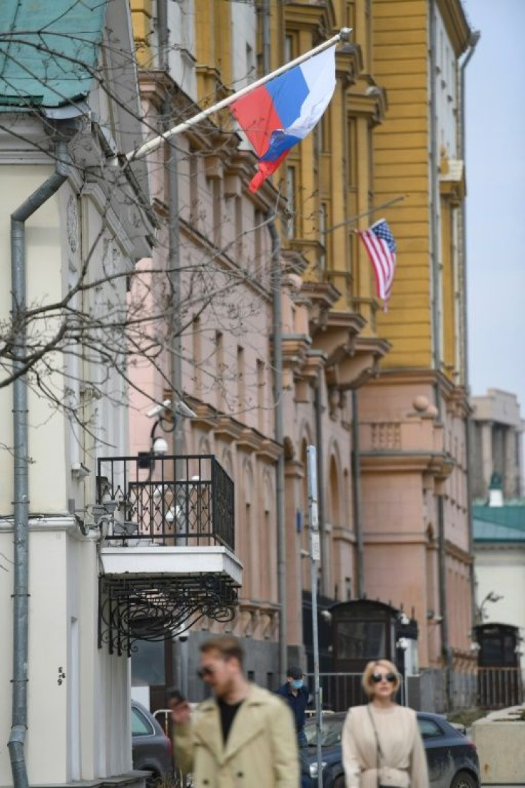 A Russian flag flies next to the US Embassy building in Moscow