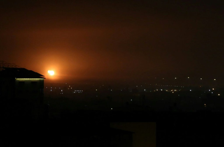 An explosion lights up the night over the Gaza Strip town of Rafah as Israel carries out airstrikes in retaliation for a rocket launch