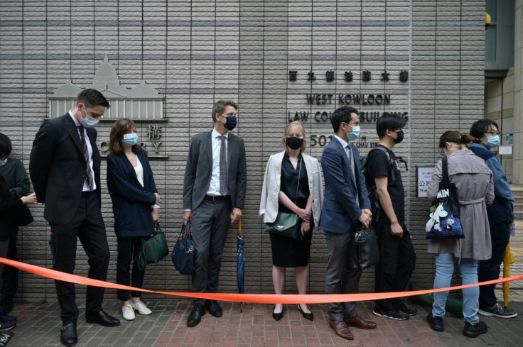 Diplomatic representatives from (L-4th R) The Netherlands, France, Sweden, Canada and Australia wait to enter the West Kowloon court in Hong Kong