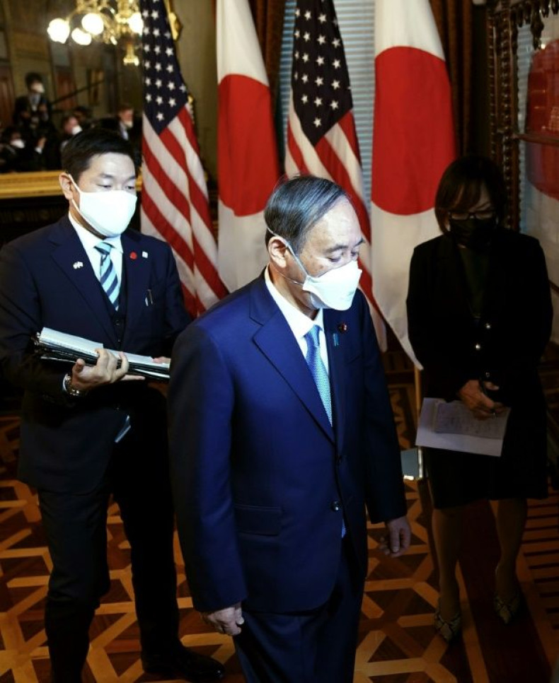 Japanese Prime Minister Yoshihide Suga arrives for a meeting with US Vice President Kamala Harris