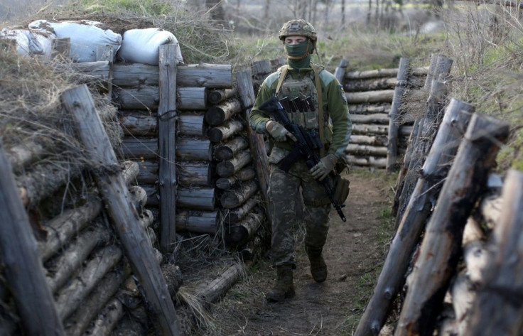 A Ukrainian soldier on patrol in a trench in Schastya, Lugansk region, near the frontline with Russia backed separatists