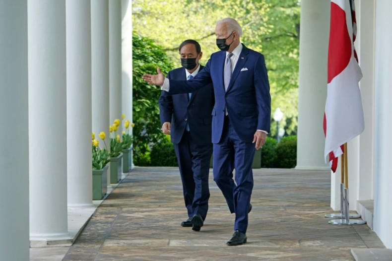US President Joe Biden and Japan's Prime Minister Yoshihide Suga walk through the Colonnade to take part in a joint press conference in the Rose Garden of the White House