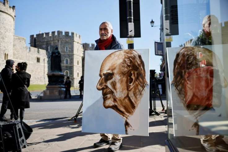 Artist Kaya Mar holding a portrait of Prince Philip ahead of the funeral Saturday