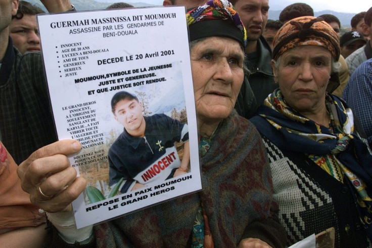 The grandmother of Massinissa Guermah, a teenager killed by Algerian  police in April 2001, holds aloft his picture in May that year, amid protests in the country's Berber heartland