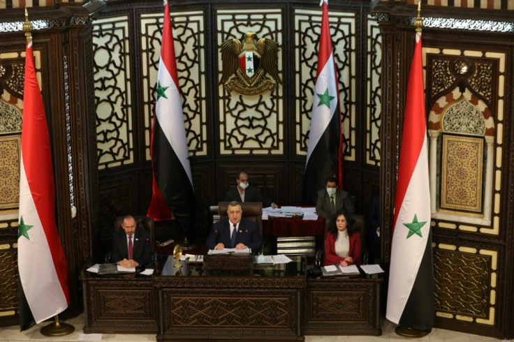 Syrian parliament speaker Hamouda Sabbagh (C) announces that presidential elections in the war-torn country will be held on May 26