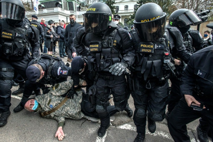 Police detain a pro-Russia demonstrator amid a protest outside the Russian Embassy in Prague