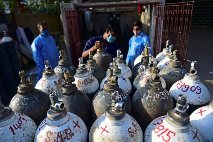 A health worker arranges oxygen cylinders needed for Covid-19 coronavirus patients at a private hospital in Allahabad, India