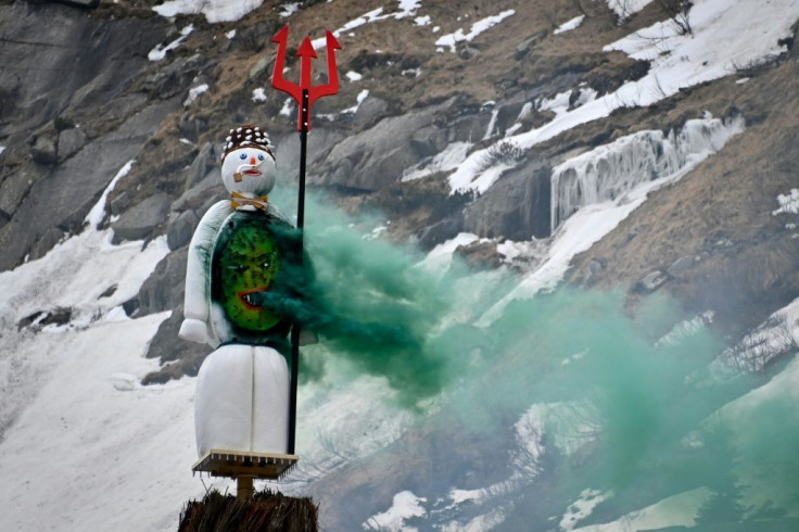 The snowman effigy burns before the fire has reached his fireworks-stuffed head