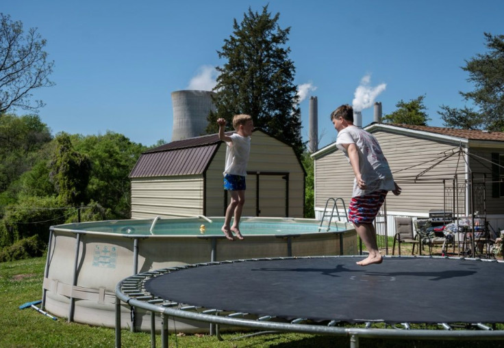 Children jump on a trampoline in Alabama near the Miller power plant, which has been ranked the top greenhouse gas-emitting plant in the United States