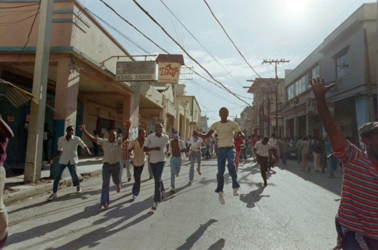 Haitians celebrate in the streets of Port-au-Prince on February 7, 1986 after the announcement that President Jean-Claude Duvalier had fled the country