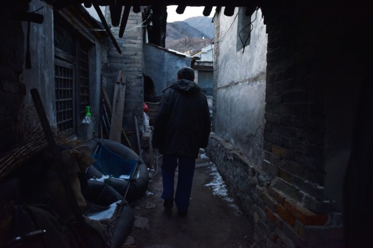 A former coal miner walks to his home in a village outside the Datai coal mine in Mentougou, west of Beijing, in December 2019, as Beijing curbs the heavily polluting energy