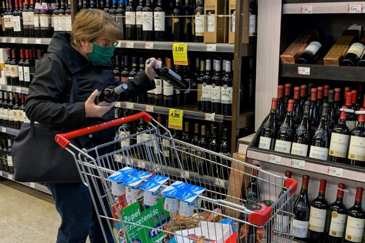 A woman wearing protective gear while shopping for wine in Santiago, Chile, in 2020, a year when wine consumption fell to its lowest level in 18 years.