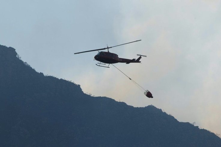 Helicopters dumped water on the flames