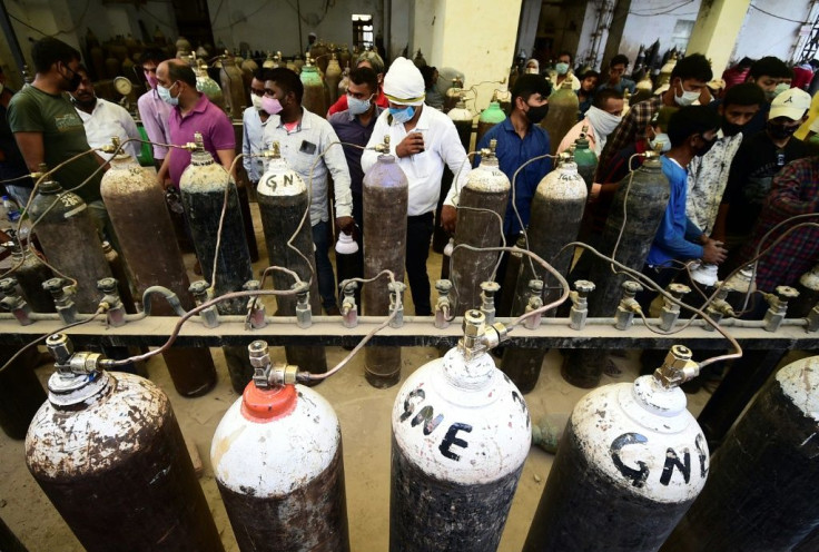Medical oxygen supplies are running dangerously low in parts of India -- here, people fill cylinders for Covid-19 coronavirus patients at a refill station in Allahabad
