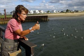 Former Alaska Governor Sarah Palin gives a thumbs up while talking to fishermen at Yankee Seafood Cooperative in Seabrook