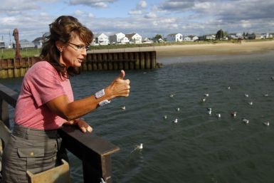 Former Alaska Governor Sarah Palin gives a thumbs up while talking to fishermen at Yankee Seafood Cooperative in Seabrook