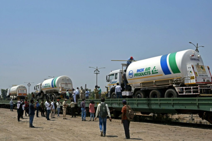 Oxygen tankers are seen being boarded on a special 'Oxygen Express' train that would bring back needed oxygen supplies to Mumbai