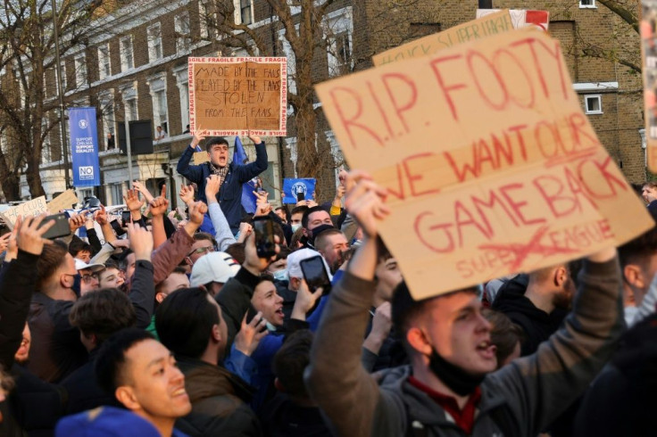 Football fans demonstrate against the proposed European Super League outside Chelsea's Stamford Bridge football stadium in London