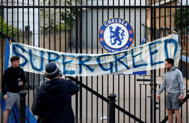 Football fans demonstrate against the proposed European Super League outside Chelsea's Stamford Bridge stadium