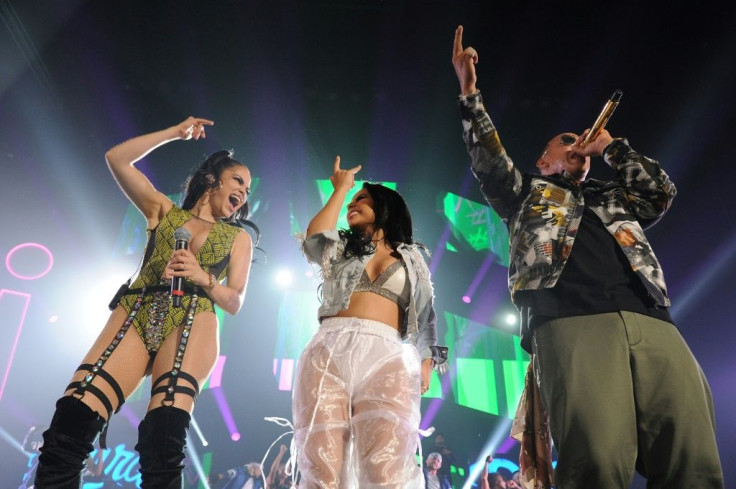 Reggaeton singers Natti Natasha, Becky G and Daddy Yankee (L to R) are seen performing at an August 2018 concert in Chicago; a new song by the two women combines sexuality and feminism, they say