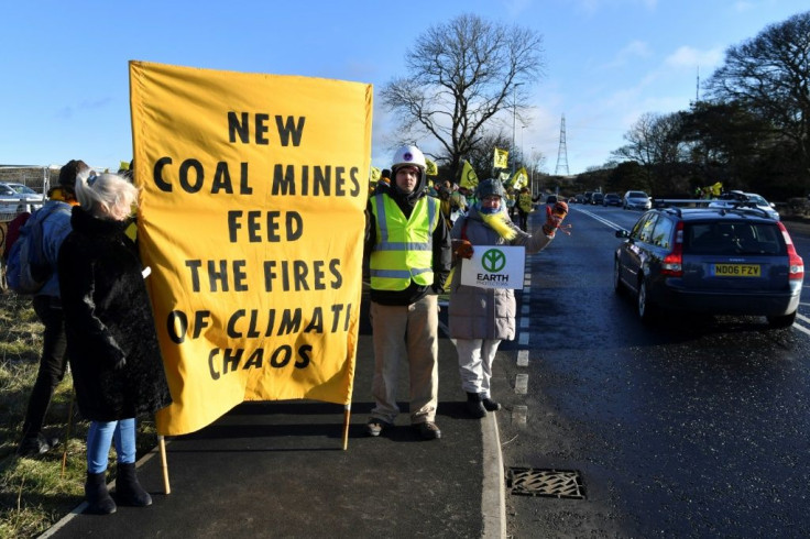 Activists from the Extinction Rebellion climate action group and local campaigners block the entrance to the site of the Bradley coal mine in the northeasern English county of Durham in February 2020